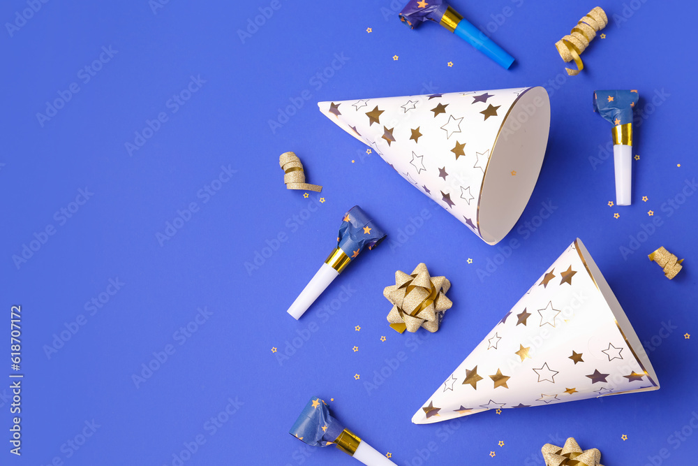 Party hats and whistles on dark blue background