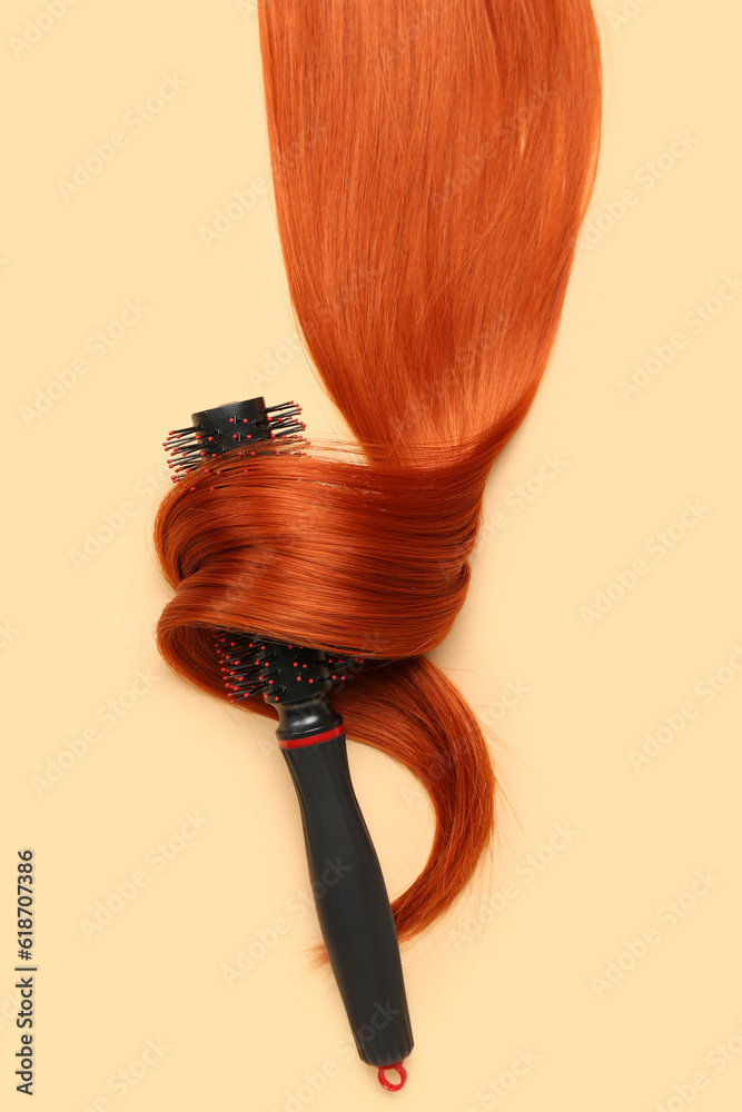 Ginger hair strand with brush on color background