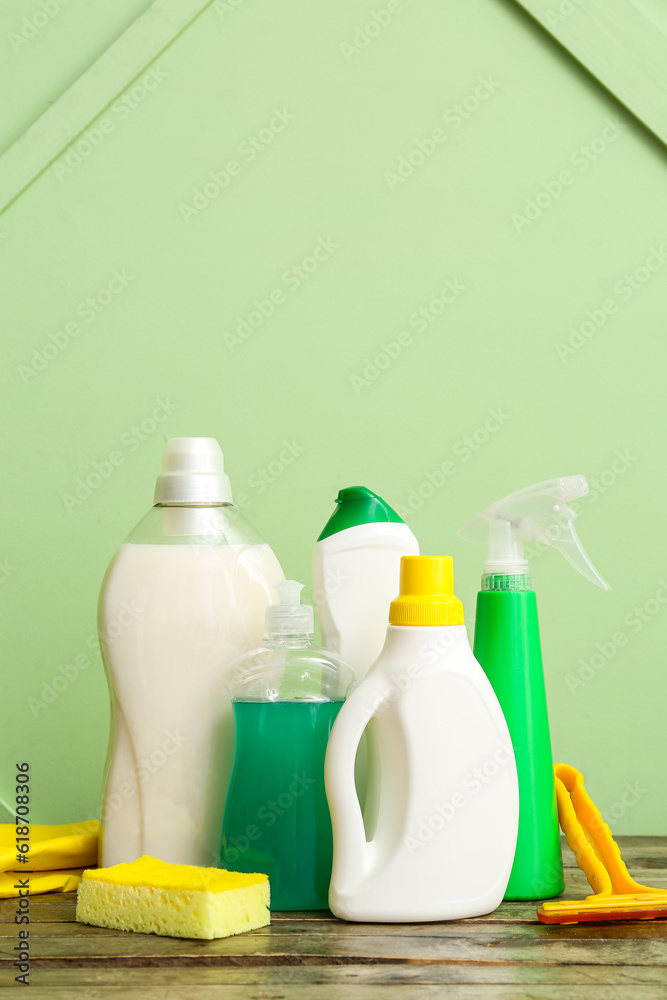 Different cleaning supplies on wooden table