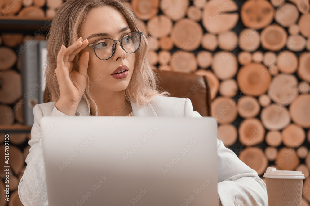 Young businesswoman working with laptop in office