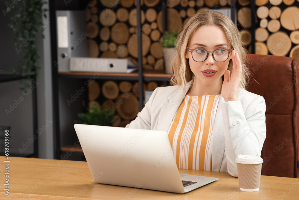 Young businesswoman working with laptop in office