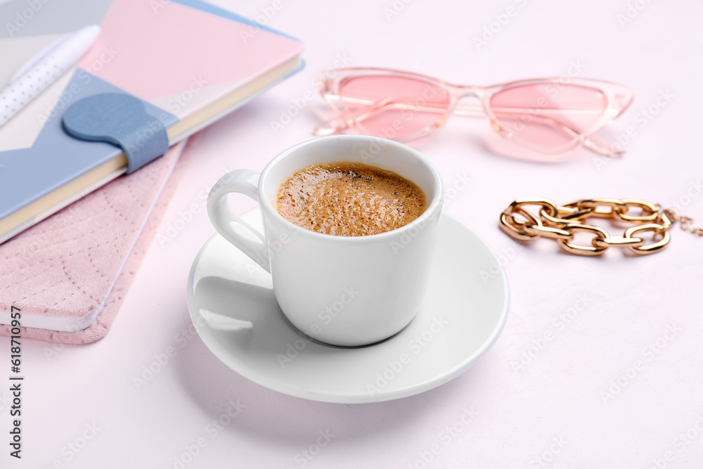 Cup of hot espresso and accessories on white background