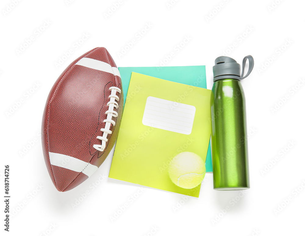 Rugby and tennis balls, notebooks with bottle of water isolated on white background