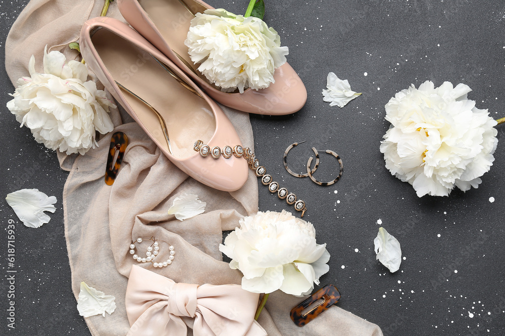 Composition with stylish female accessories, high heels and beautiful peony flowers on dark backgrou