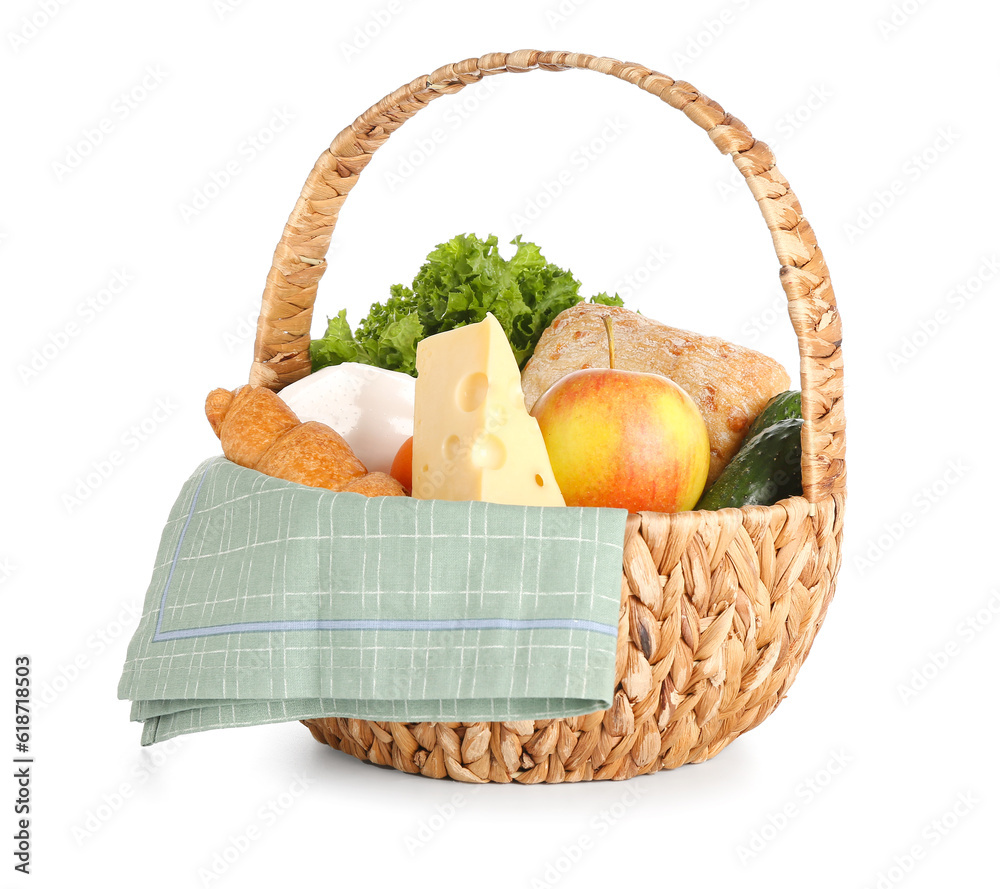 Wicker basket with delicious food for picnic on white background