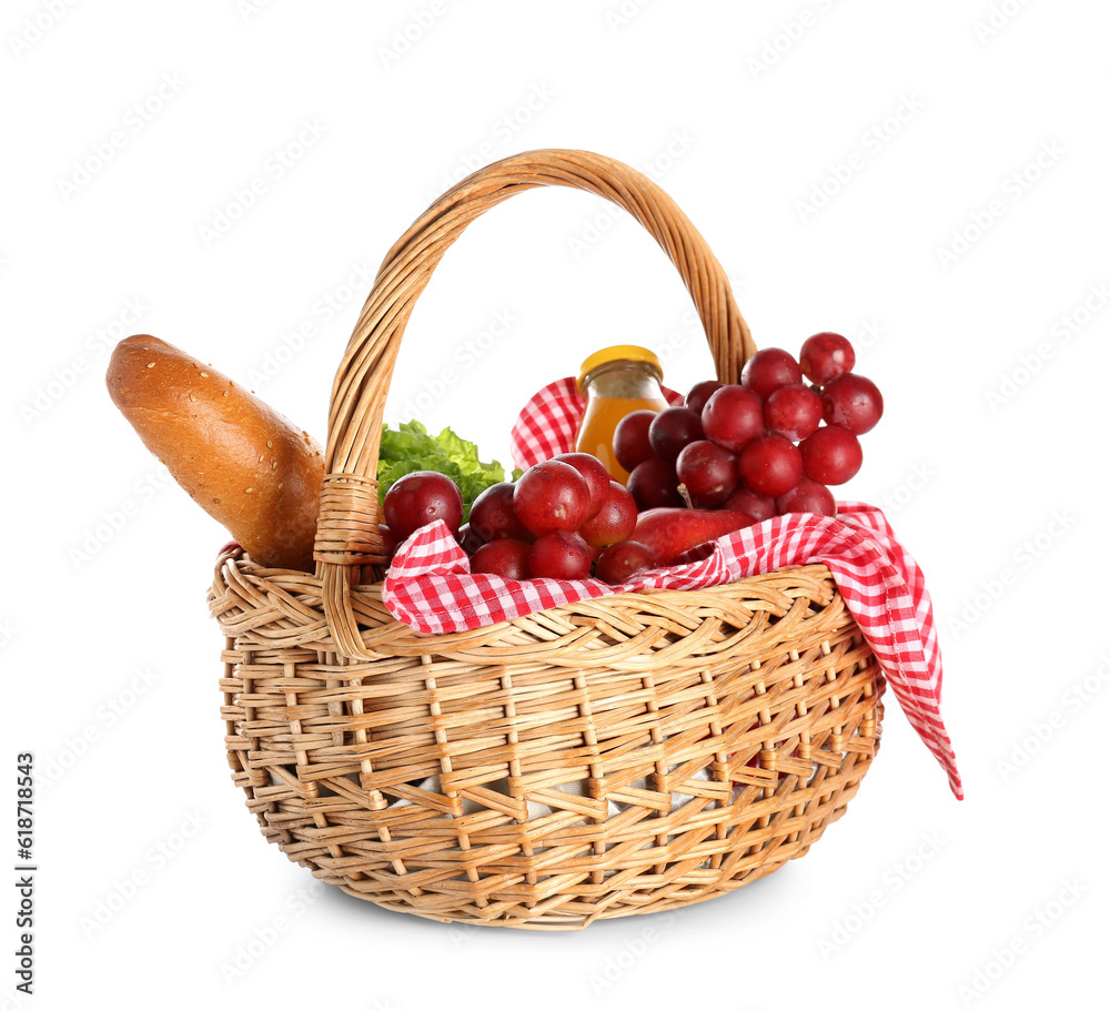 Wicker basket with tasty food for picnic and juice on white background