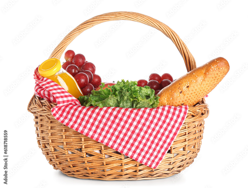 Wicker basket with tasty food for picnic and juice on white background