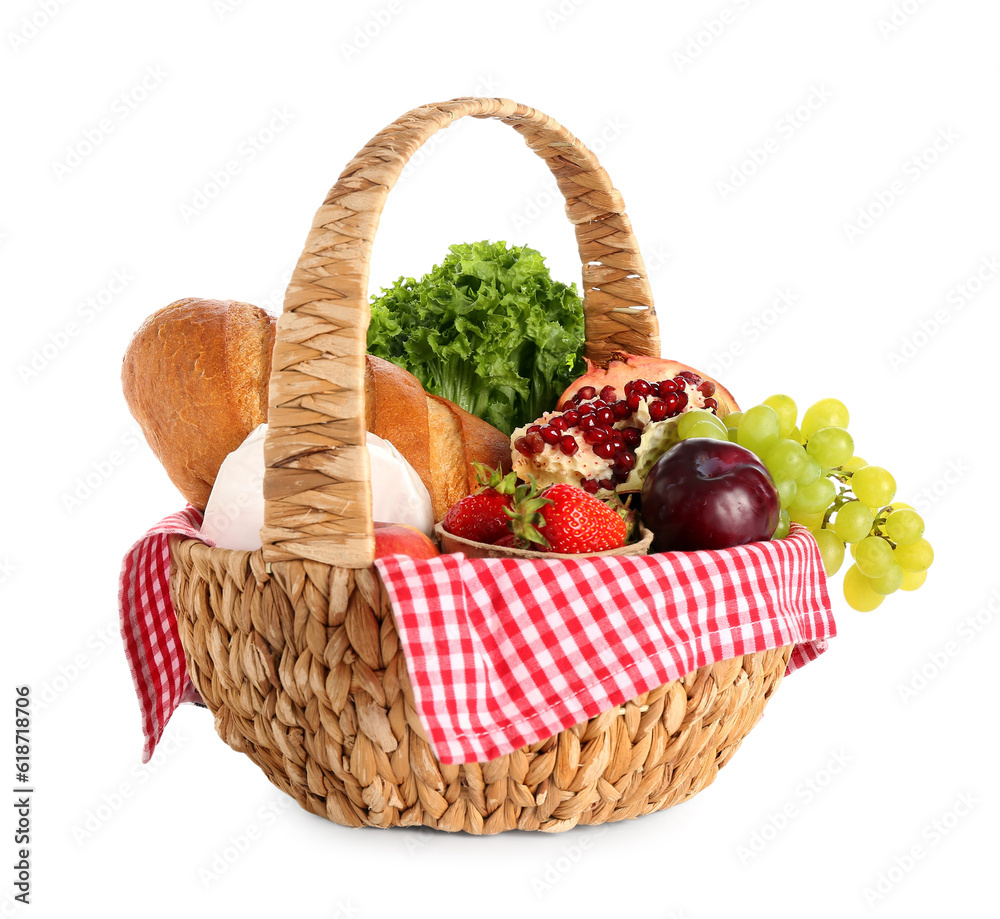 Wicker basket with delicious food for picnic on white background