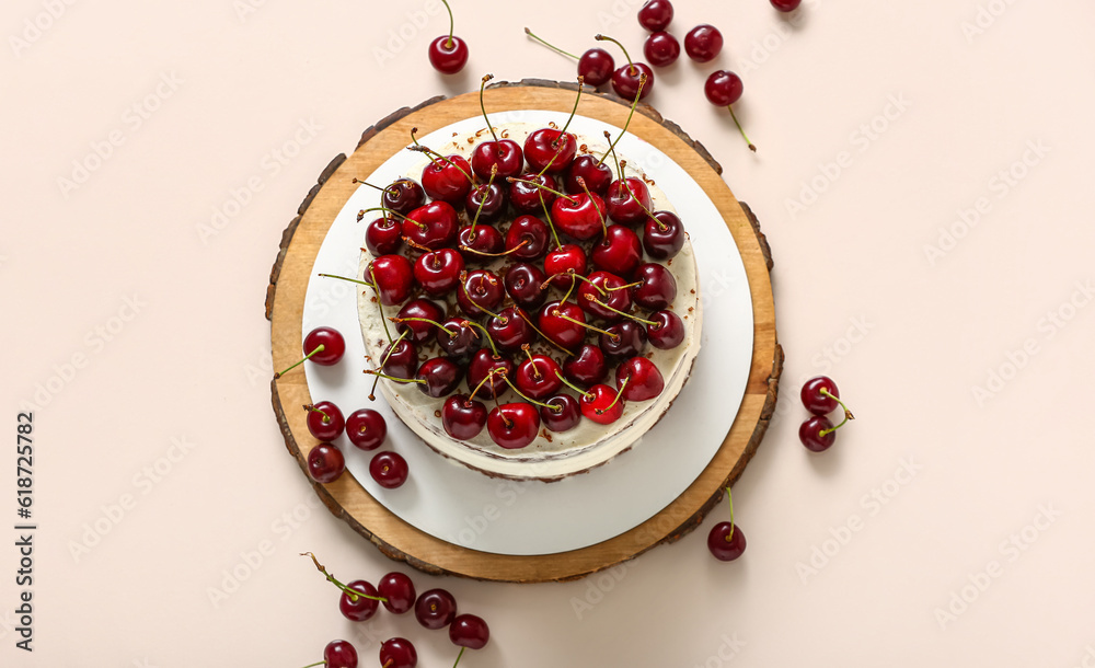 Wooden board with tasty cherry cake on white background