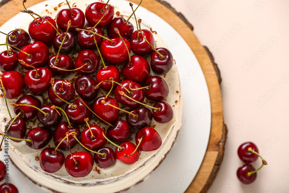 Wooden board with tasty cherry cake on white background