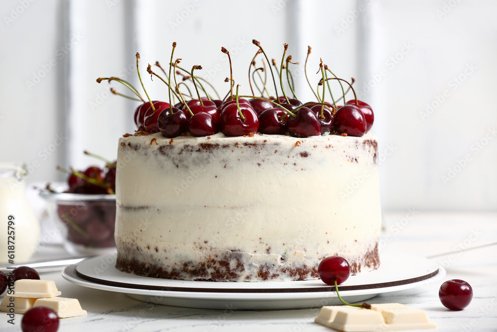 Plate with tasty cherry cake on table