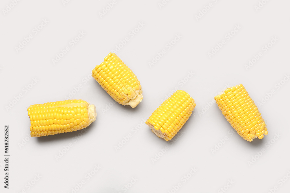 Cut fresh corn cobs on grey background