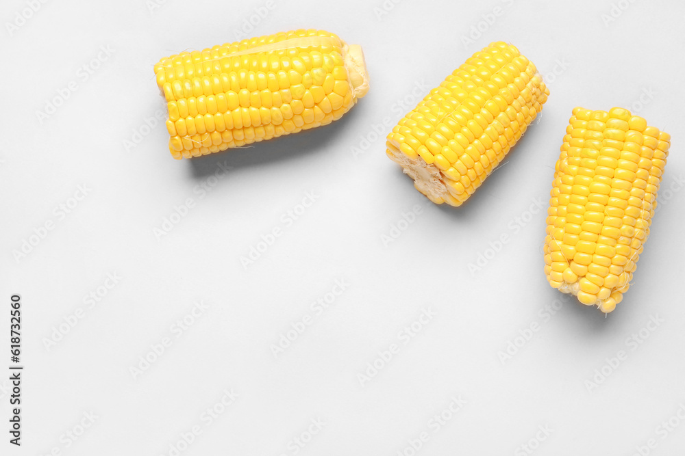 Cut fresh corn cobs on grey background