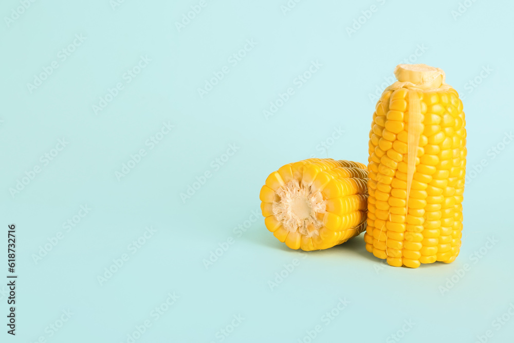 Cut fresh corn cobs on blue background