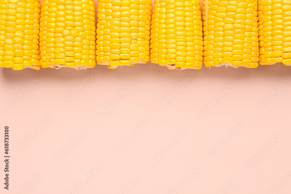 Cut fresh corn cobs on pink background