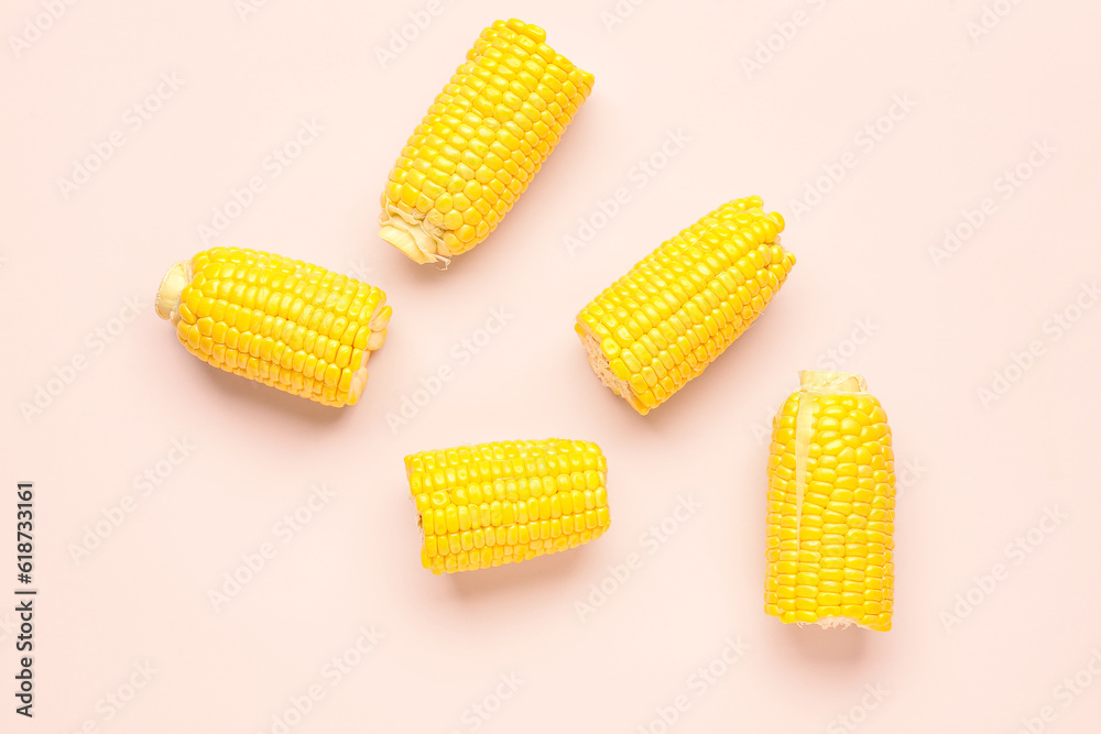 Cut fresh corn cobs on pink background