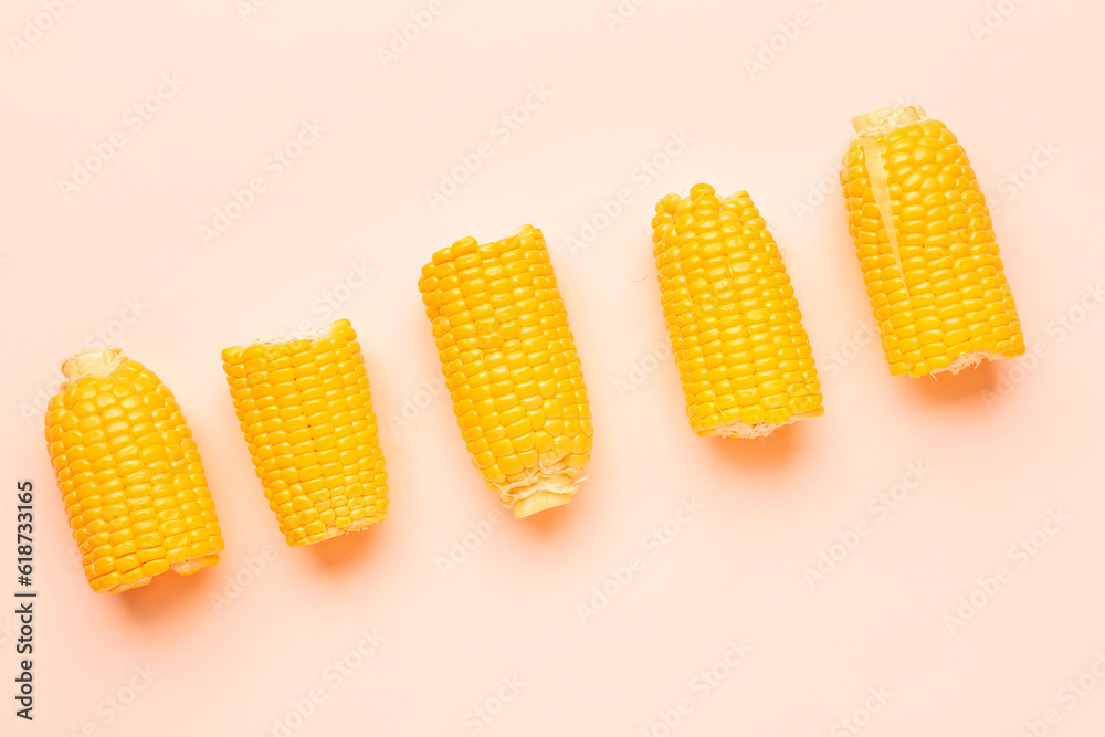 Cut fresh corn cobs on pink background