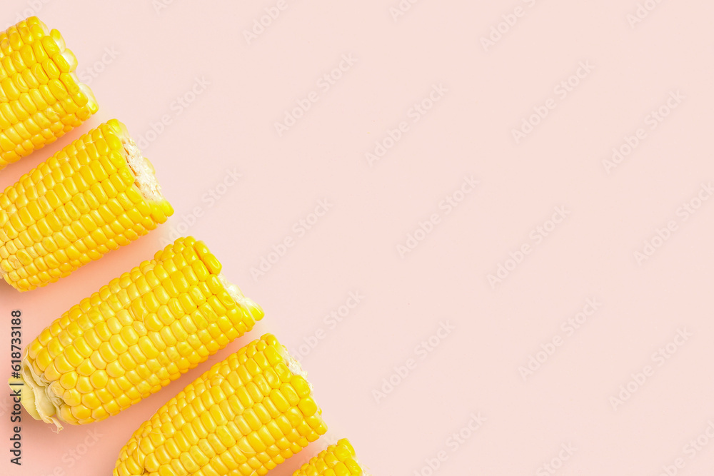 Cut fresh corn cobs on pink background