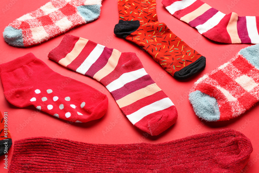 Different socks on red background, closeup