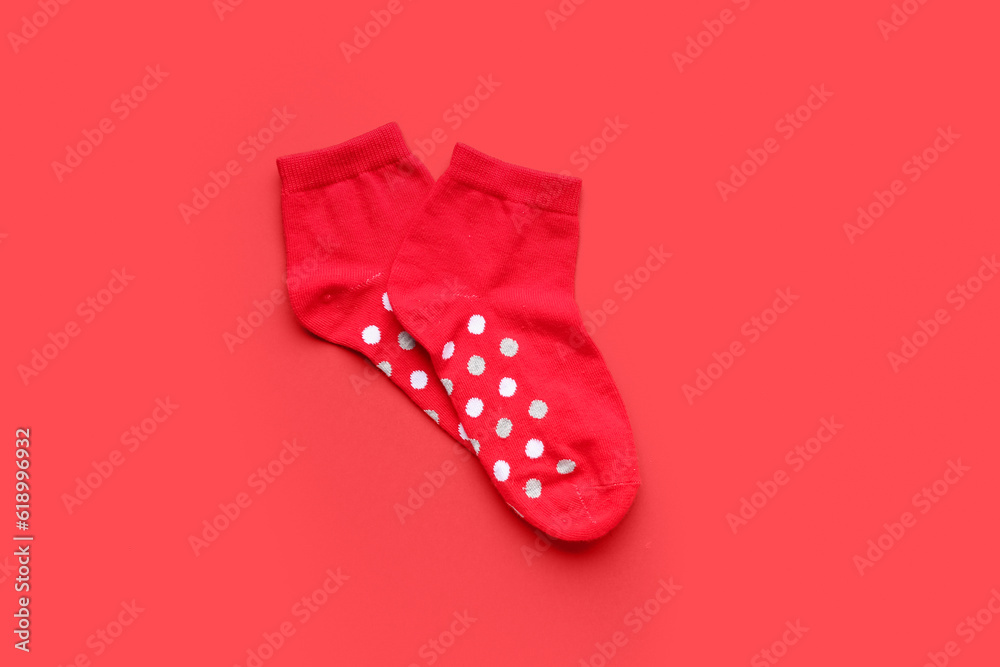 Pair of cotton socks on red background