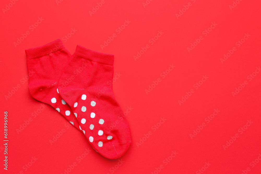 Pair of cotton socks on red background