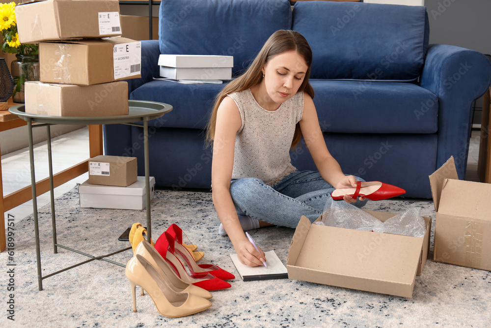 Young woman packing parcel for client with shoes at home