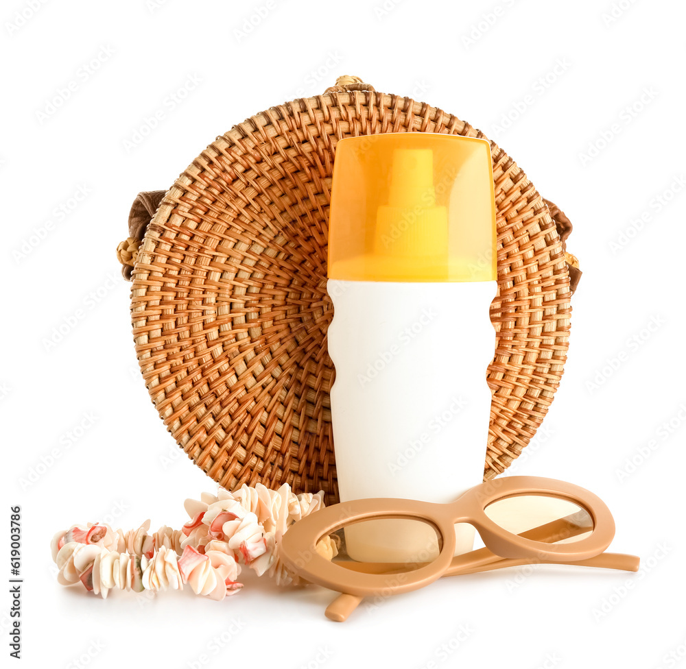 Seashell necklace with wicker bag, sunglasses and bottle of sunscreen cream isolated on white backgr