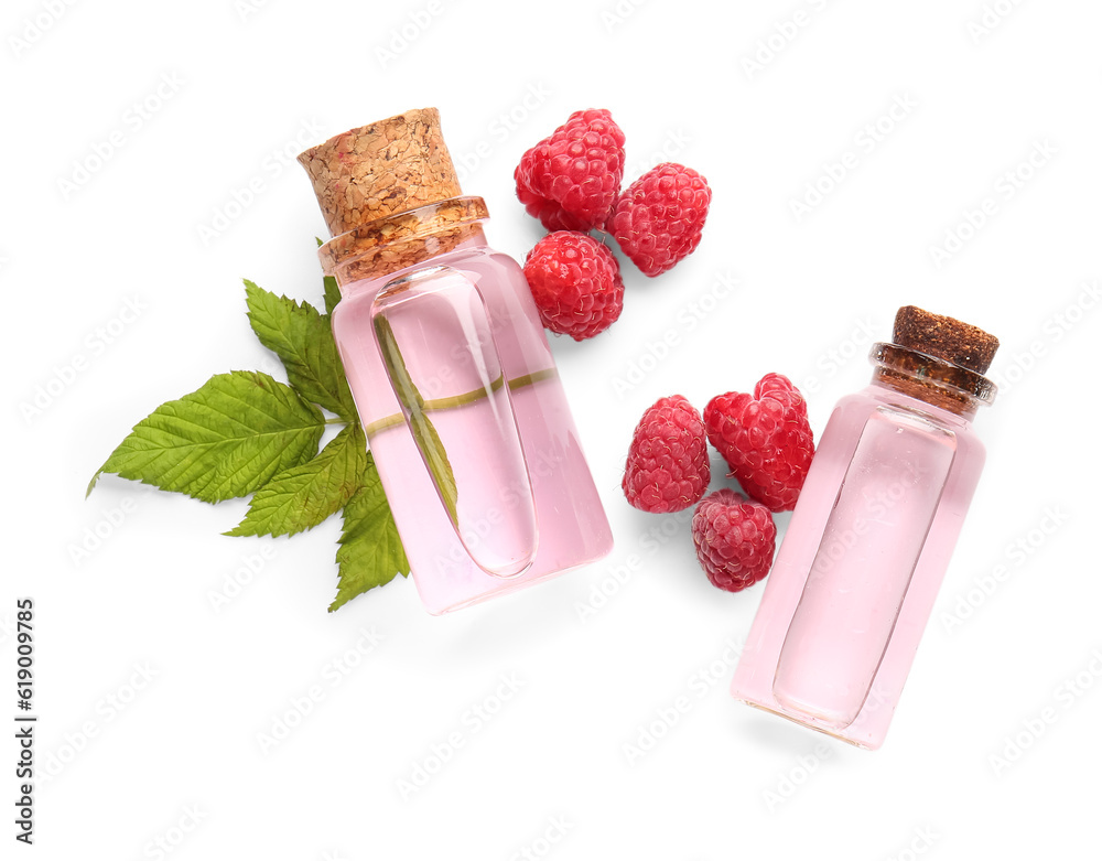 Bottles of cosmetic raspberry oil on white background