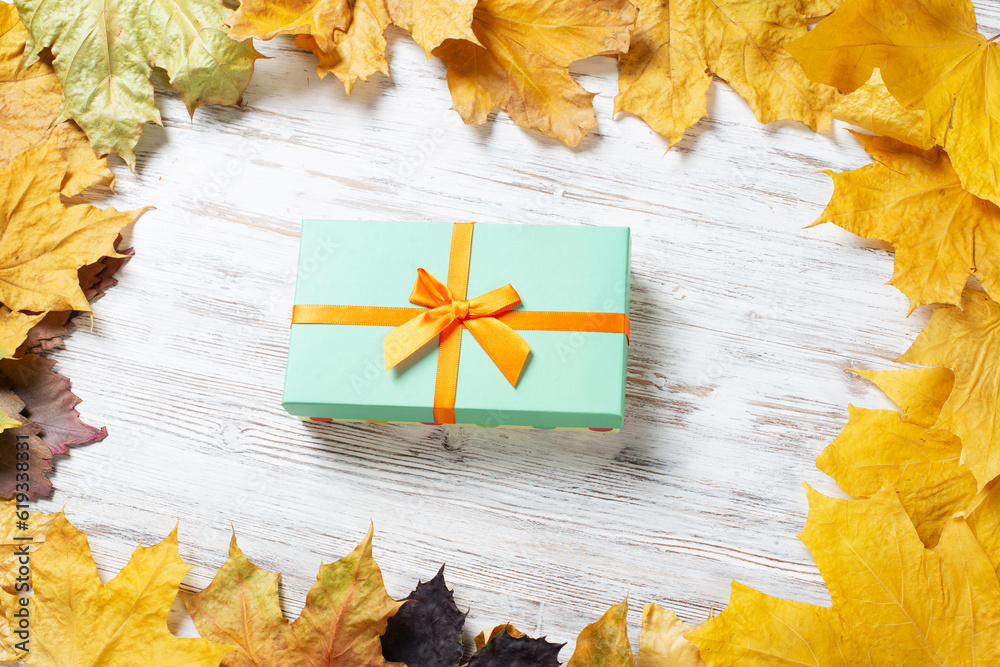 Bright autumn composition with gift box