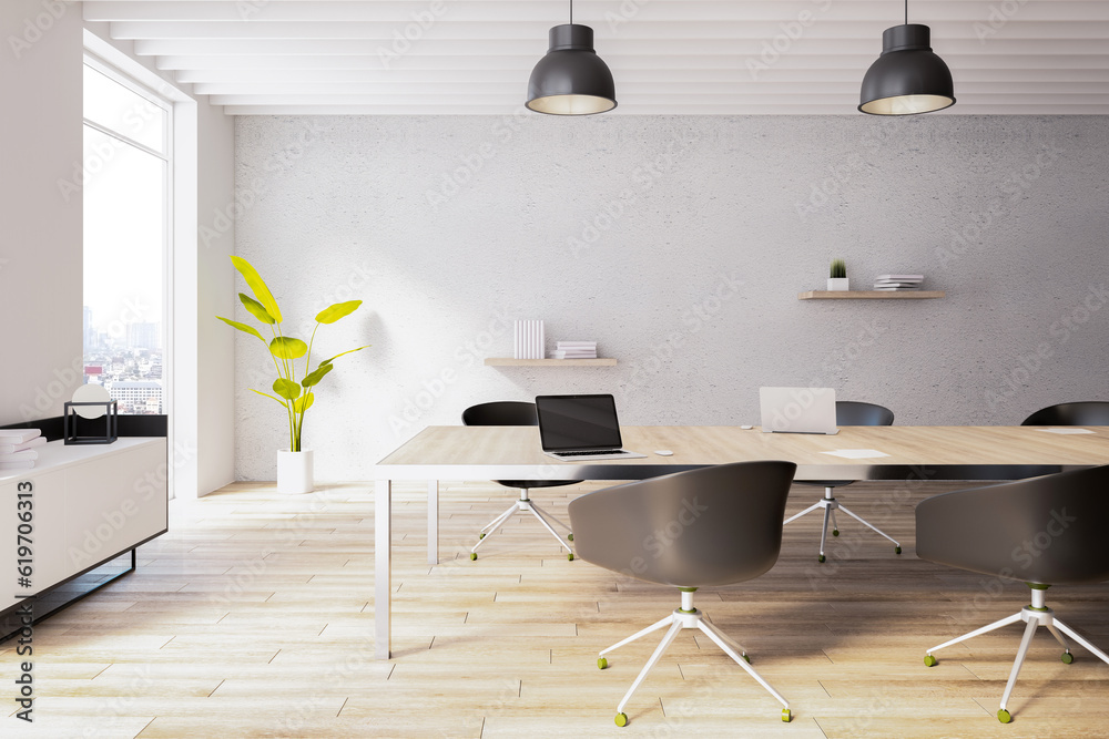 Side view of sunny modern office coworking interior with large wooden desk, armchairs, concrete wall