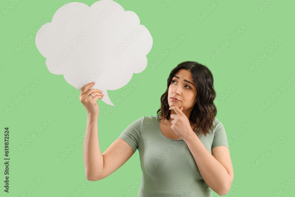 Thoughtful young pregnant woman with blank speech bubble on green background