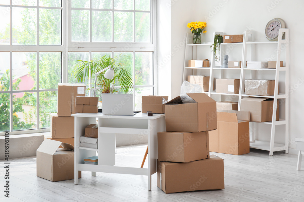 Interior of office with workplace and parcels