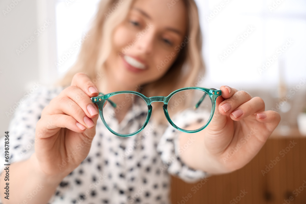 Young woman with stylish eyeglasses at home, closeup