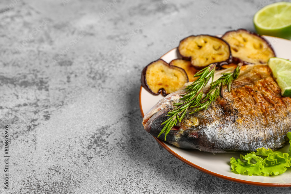 Plate with tasty grilled dorado fish on light background