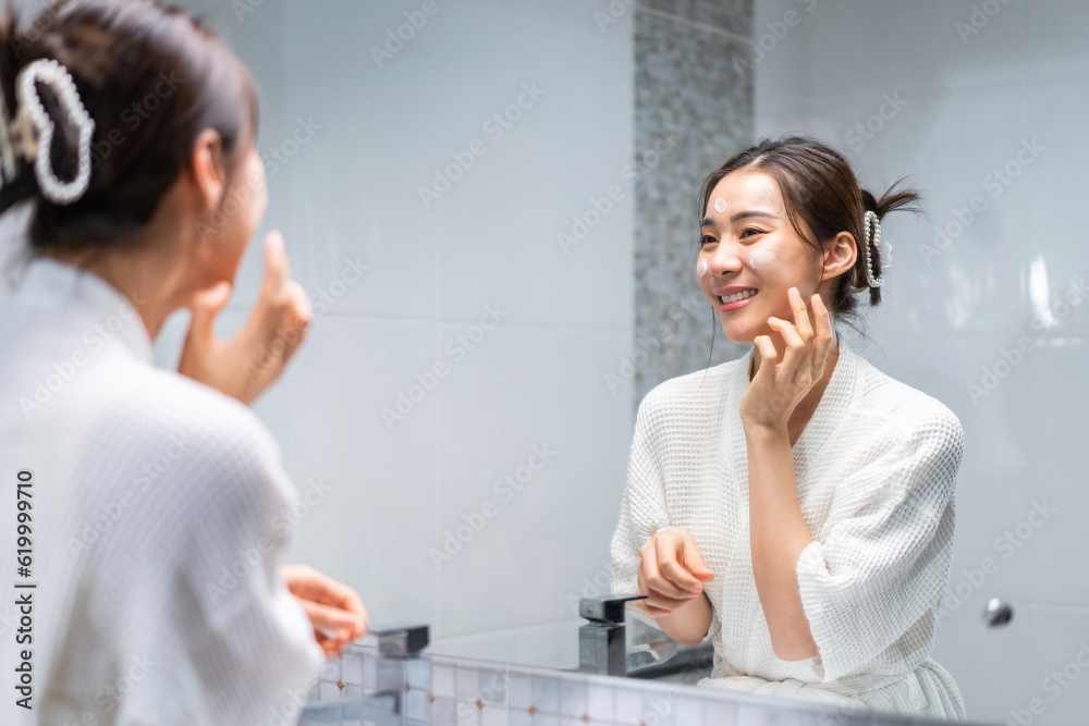 Asian beautiful woman washing her clean face with facial foam and water. 