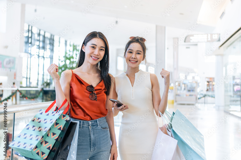 Portrait of Asian attractive two girl shopping indoor in shopping mall. 