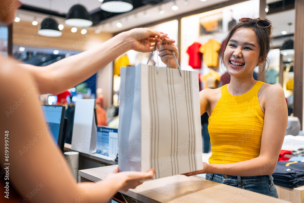 Asian beautiful women purchasing clothes product in shopping mall. 