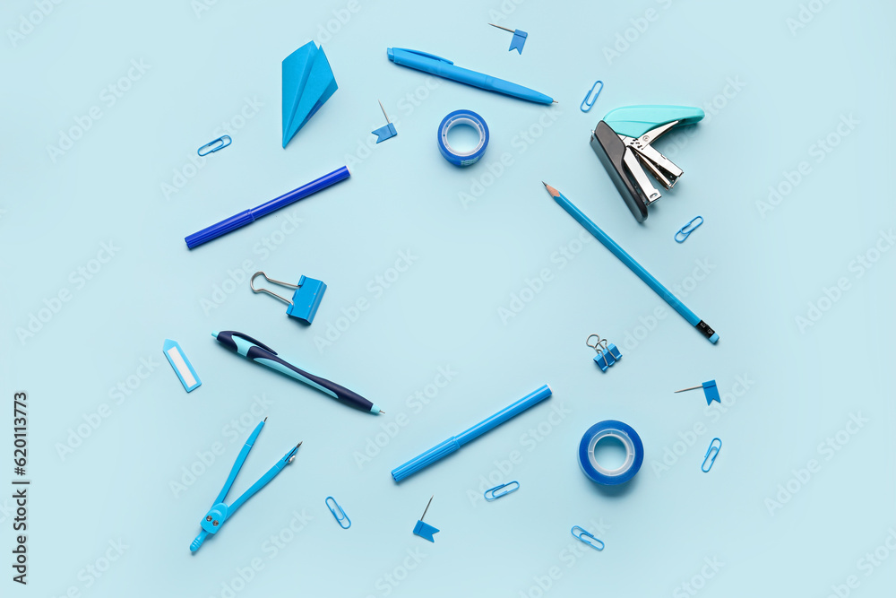 Frame made of stationery supplies on blue background