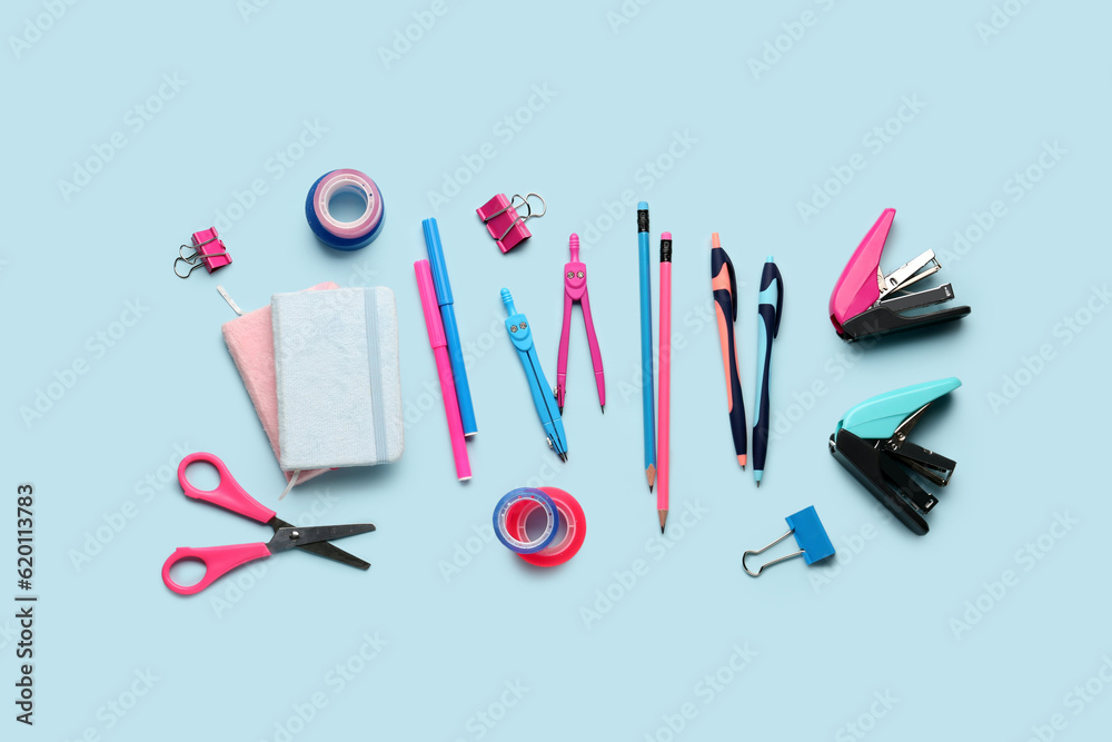 Composition with stationery supplies on blue background