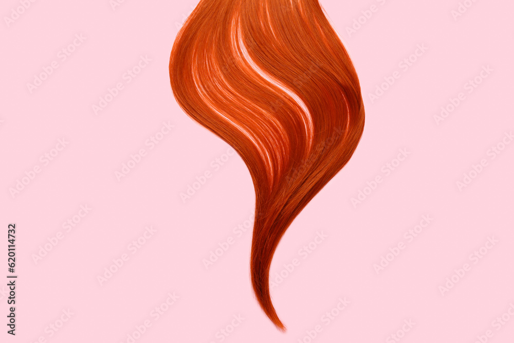 Ginger hair strand on pink background, closeup