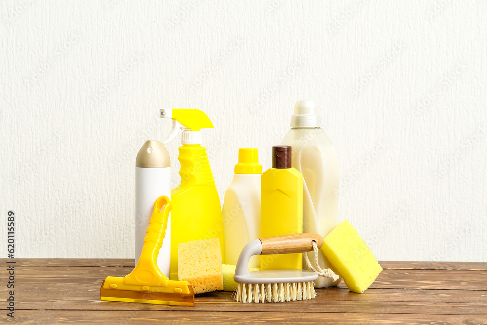 Set of cleaning supplies on wooden table