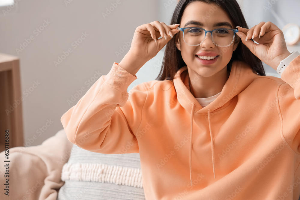 Beautiful young woman wearing glasses at home