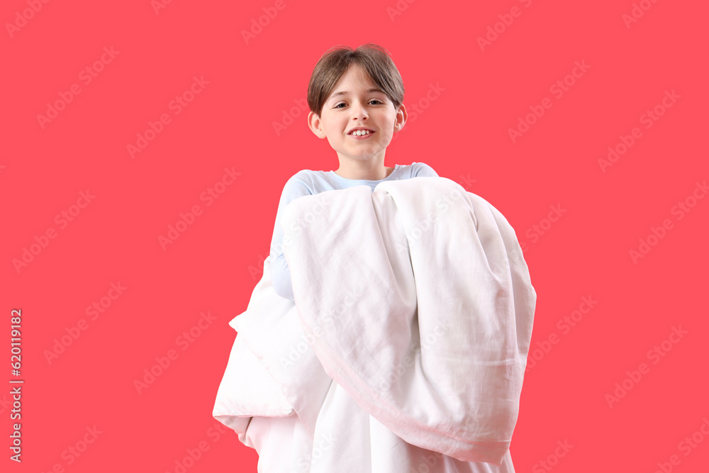 Little boy with blanket on red background