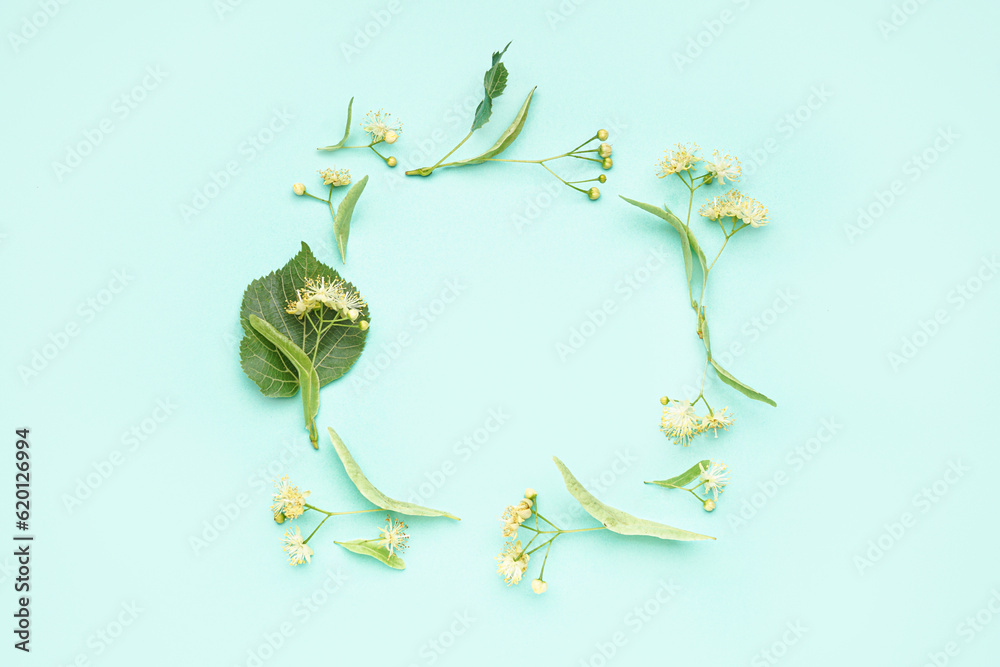 Frame made of fresh linden flowers on color background