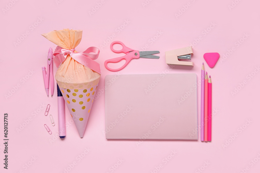 School cone with different stationery on pink background