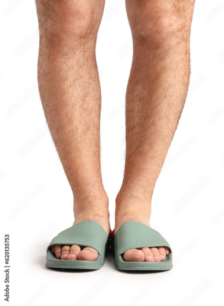 Male legs in flip-flops on white background