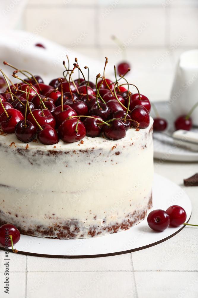 Tasty cherry cake on white tile background