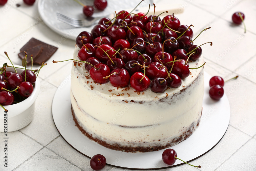 Tasty cherry cake on white tile background