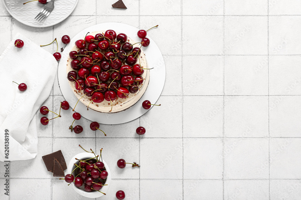 Tasty cherry cake on white tile background