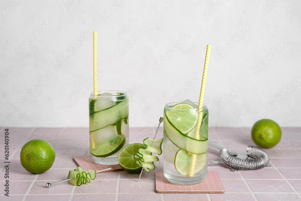 Glasses of mojito with cucumber on tile table